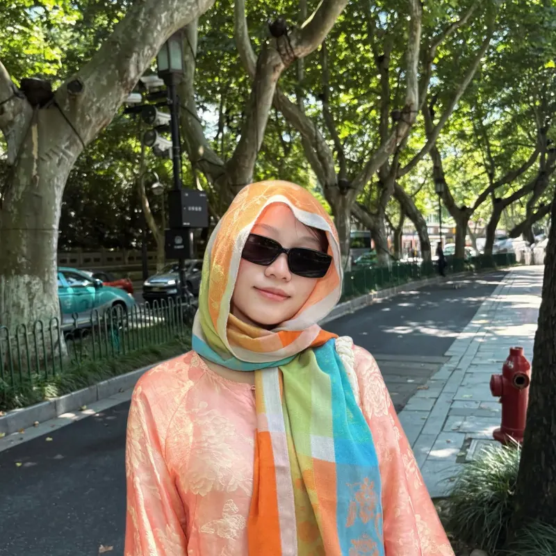 Look 03: a peach jacquard top, a rainbow silk headscarf and black sunglasses on a tree-lined avenue.